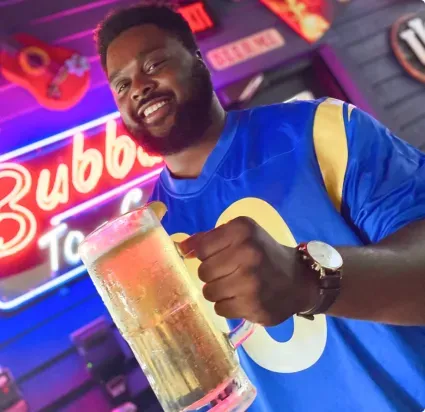 Guy holding a large beer